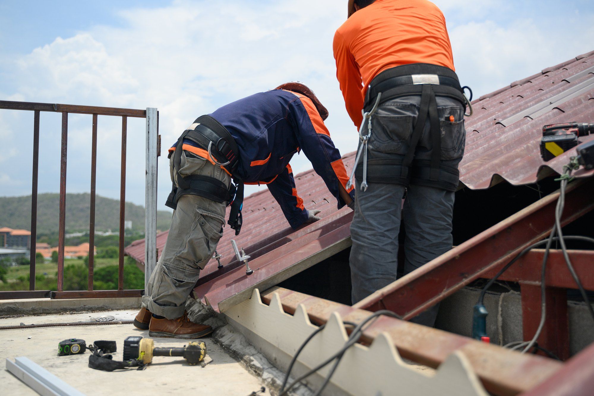 Roofing team working on the roof of a larger building