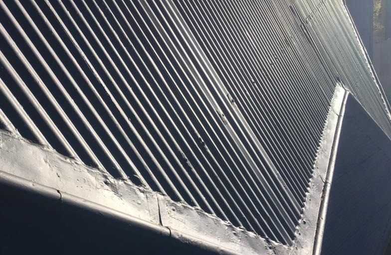 Close-up of metal roof sheeting along a roof edge
